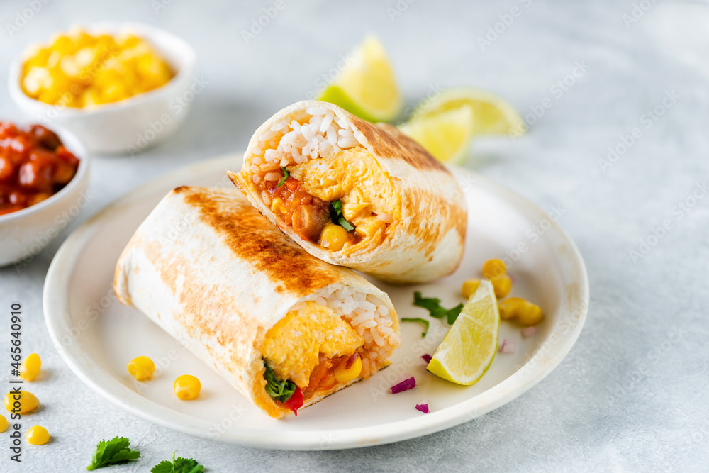 Breakfast tortilla wrap with omelet, beans and vegetables. No meat burrito sandwich Breakfast tortilla wrap with omelet, beans and vegetables. No meat burrito sandwich