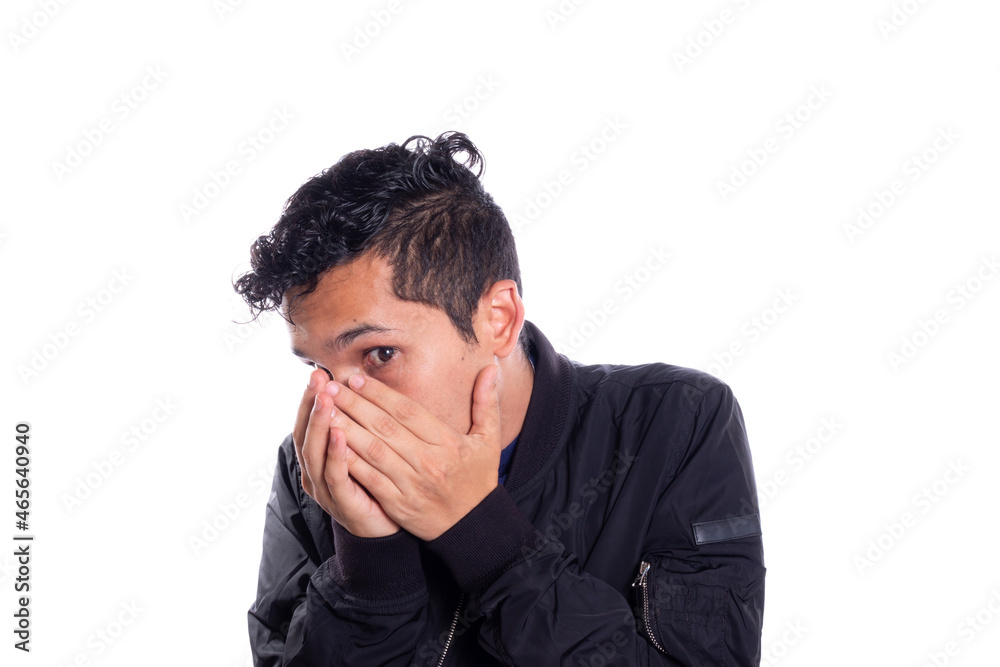 Embarrassed man covering his face, isolated on white background. Young latin adult young man being accused. Embarrassed man covering his face, isolated on white background. Young latin adult young man being accused.
