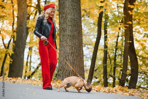 woman with dog walking in the park