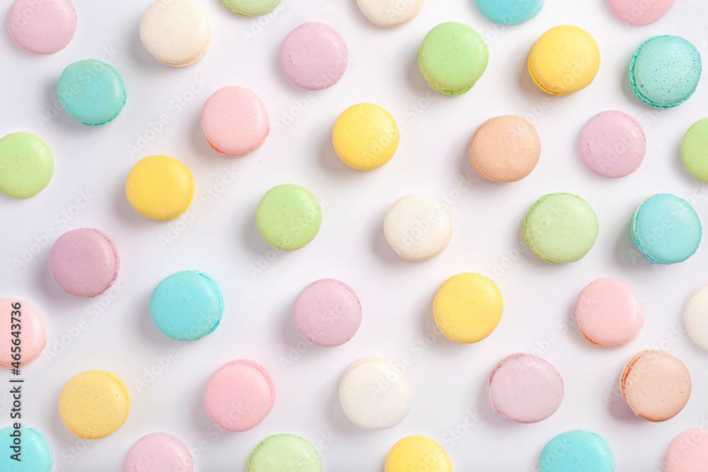 The colorful pastel French macaron cookies on a white background, Contemporary Easter flat lay The colorful pastel French macaron cookies on a white background, Contemporary Easter flat lay