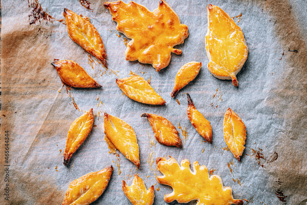 baking cookies in the form of autumn leaves on parchment paper baking cookies in the form of autumn leaves on parchment paper