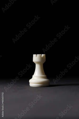 isolated white rook chess piece on black background. photo