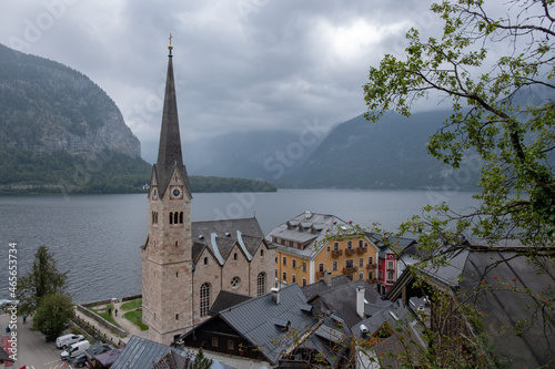 Hallstatt Lutheran Church and buildings roofs with lake and mountains at the background, in a cloudy autumn day. Austrian state of Upper Austria. © A.Pushkin