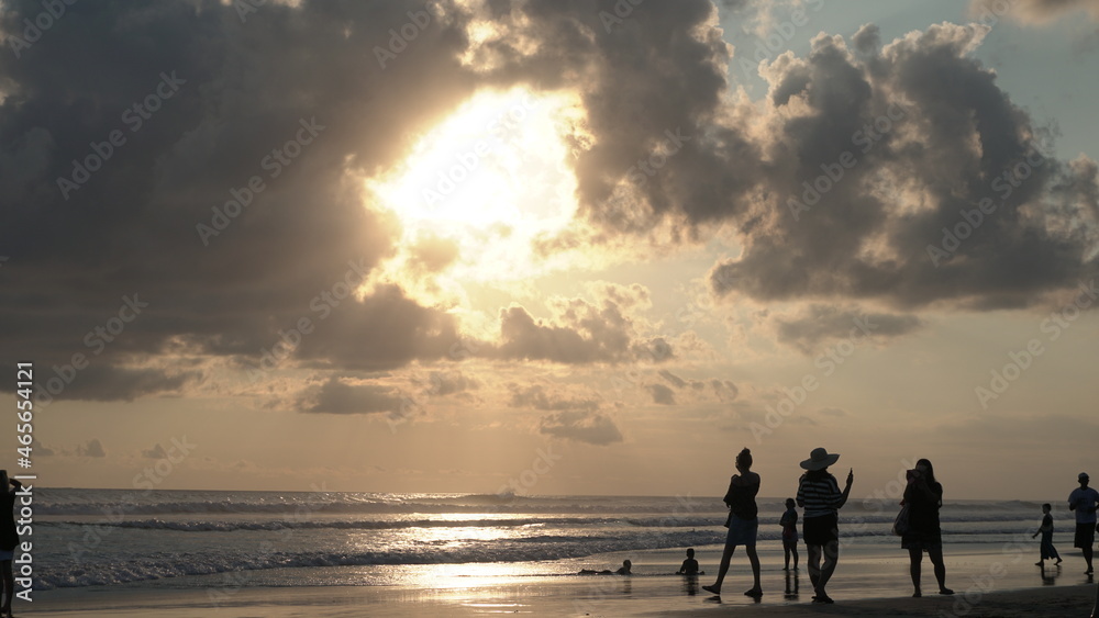 people walking on the beach at sunset Kuta Indonesia Bali travel summer vacation ocean waves sand nature relax colors clouds sun silhouette