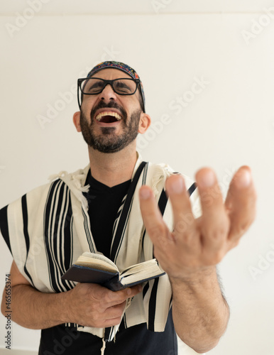 Jewish Bearded Man Praying with a big kip on his head. the man in showing he's hand during singing