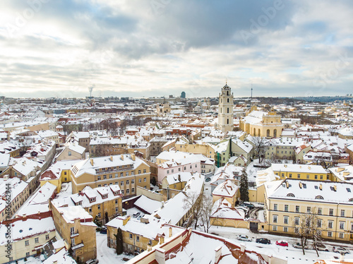 Fototapeta Naklejka Na Ścianę i Meble -  Beautiful Vilnius city panorama in winter with snow covered houses, churches and streets. Aerial view. Winter city scenery in Vilnius, Lithuania.