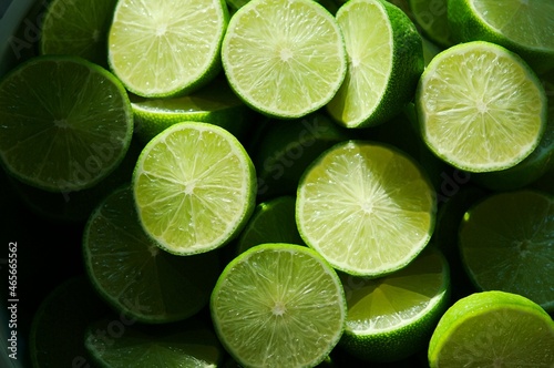 Lime Background with sunlight form outside. Close up shot of limes. Selective Focus of sliced lime. Lime is a kind of fruit. The result is very sour for cook the Thai food style