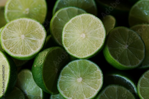 Lime Background with sunlight form outside. Close up shot of limes. Selective Focus of sliced lime. Lime is a kind of fruit. The result is very sour for cook the Thai food style