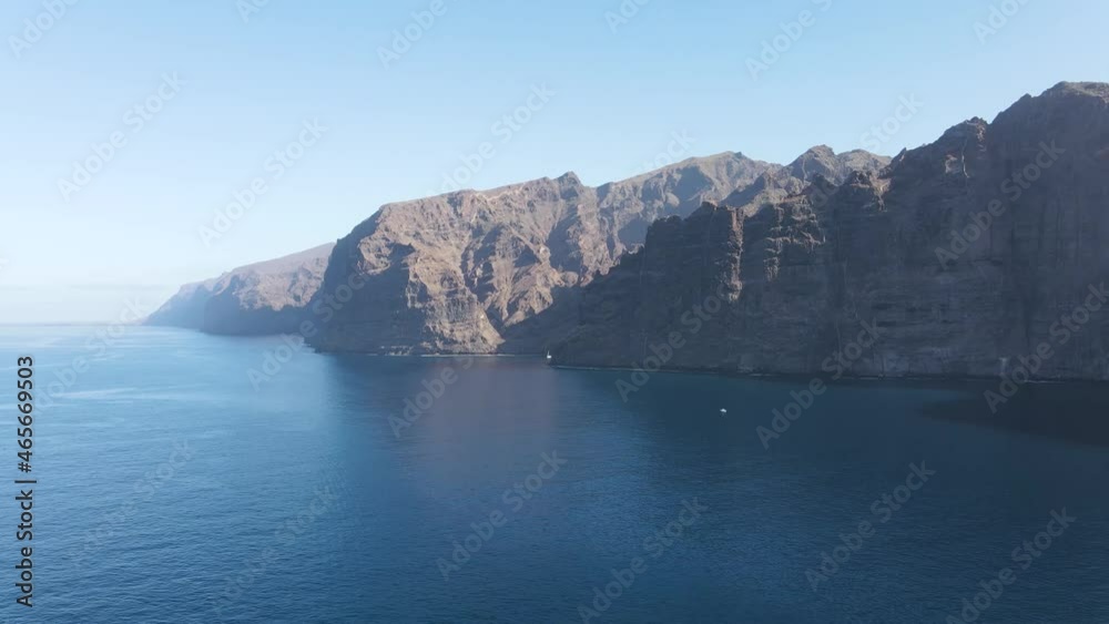 Amazing aerial view of Los Gigantes cliffs on Tenerife, Canary Islands, Spain. Clear sky with the sunlight illuminating the Atlantic coast. Amazing aerial view of Los Gigantes cliffs on Tenerife, Canary Islands, Spain. Clear sky with the sunlight illuminating the Atlantic coast.