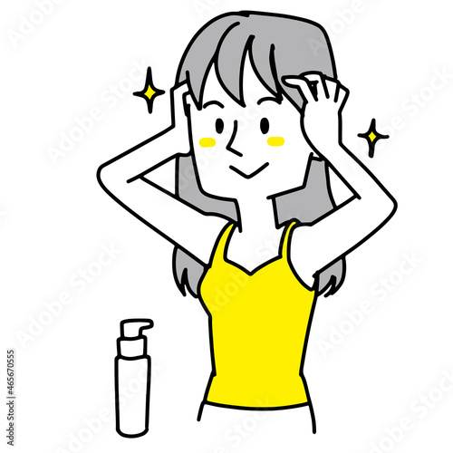 髪の毛をお手入れしている女性