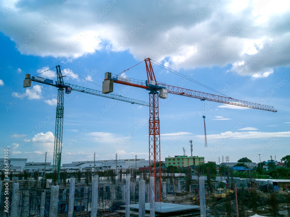 Hammerhead tower cranes. Blue sky background and clouds. Hammerhead tower cranes. Blue sky background and clouds.