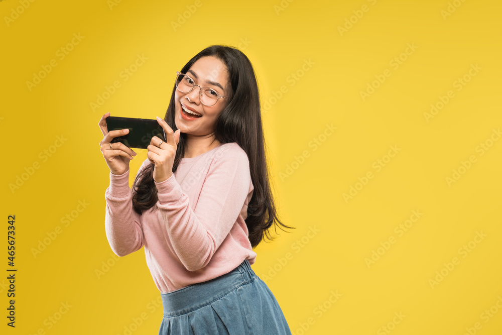 beautiful woman laughing looking at the screen of a smartphone beautiful woman laughing looking at the screen of a smartphone