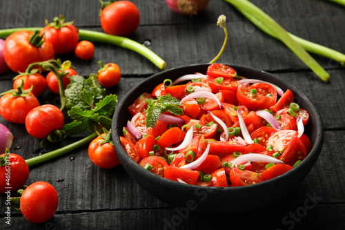 Healthy organic tomato salad - vegan raw diet foods background.