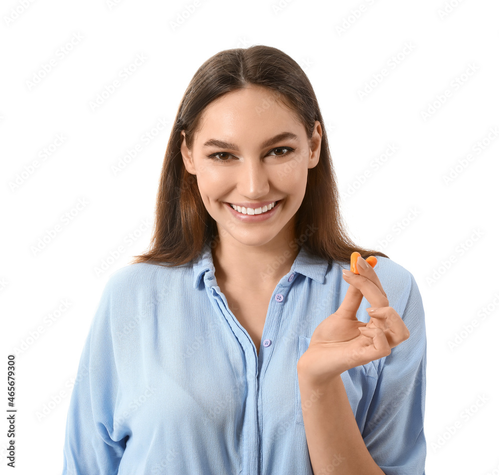 Young woman with earplugs on white background Young woman with earplugs on white background