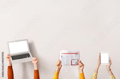Fototapeta People with newspaper, laptop and tablet computer on light background