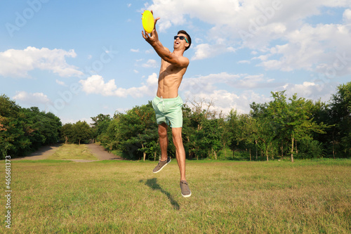 Young man playing frisbee i...