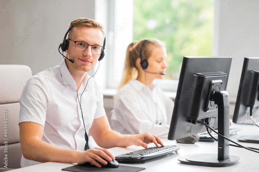 Diverse team of young professionals is working in the phone support office. Working day of sales managers in the call center. Business, telephone consulting and problem solving. Diverse team of young professionals is working in the phone support office. Working day of sales managers in the call center. Business, telephone consulting and problem solving.