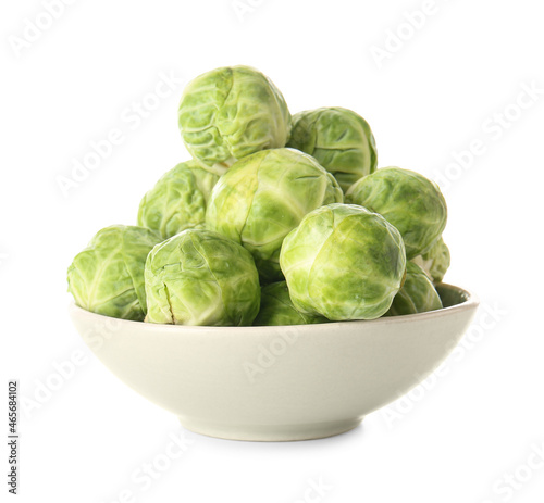 Bowl with raw Brussels sprouts on white background