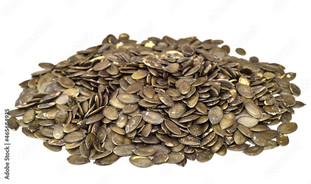 Heap of pumpkin seeds isolated on the white background. Selective focus. Healthy food concept. Heap of pumpkin seeds isolated on the white background. Selective focus. Healthy food concept.