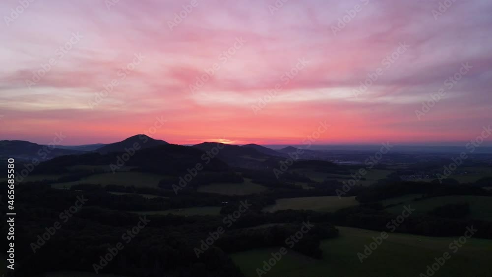 Aerial view of hilly landscape of meadows woods field during sunset on golden sunset background. Aerial view of hilly landscape of meadows woods field during sunset on golden sunset background.