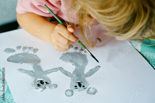 Photography Little creative toddler girl painting with finger colors koala bear