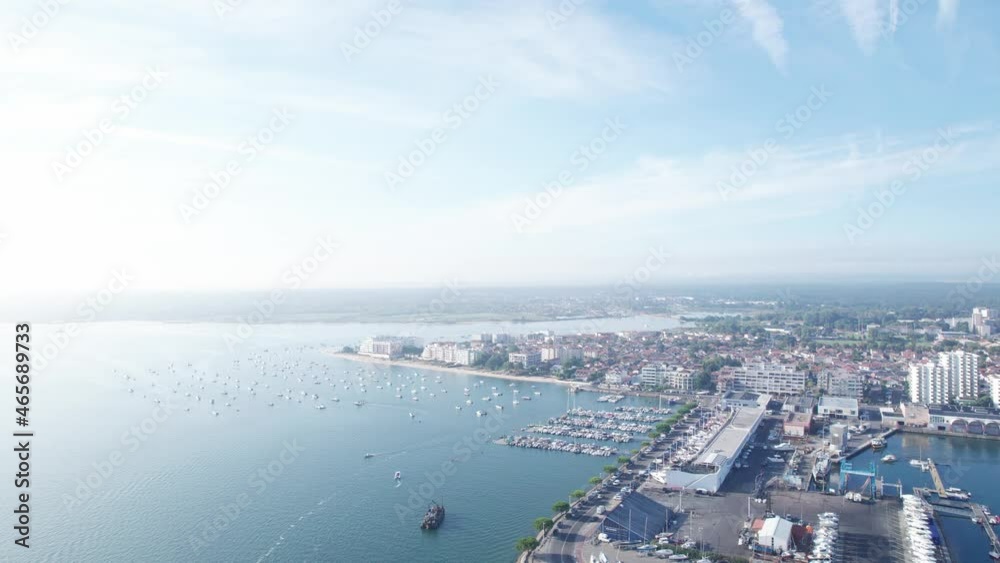 Panoramic view of Arcachon city and moored boats on sea water, France. Aerial forward Panoramic view of Arcachon city and moored boats on sea water, France. Aerial forward