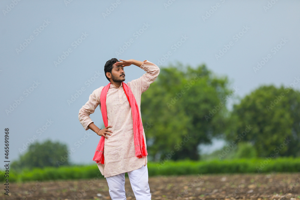 Indian farmer working with bull at agriculture field and looking on sky waiting for the rain. Indian farmer working with bull at agriculture field and looking on sky waiting for the rain.