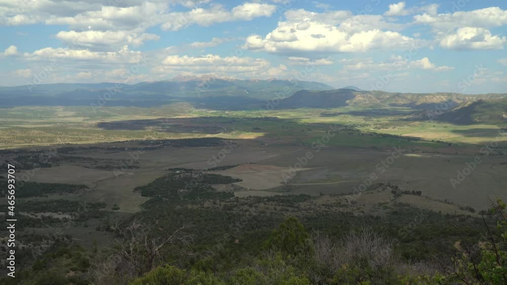 Time lapse of the Mancos river valley showing clouds and shadows moving, beautiful farm land, highway 160, and the San Juan Mountains in the distance. Time lapse of the Mancos river valley showing clouds and shadows moving, beautiful farm land, highway 160, and the San Juan Mountains in the distance.
