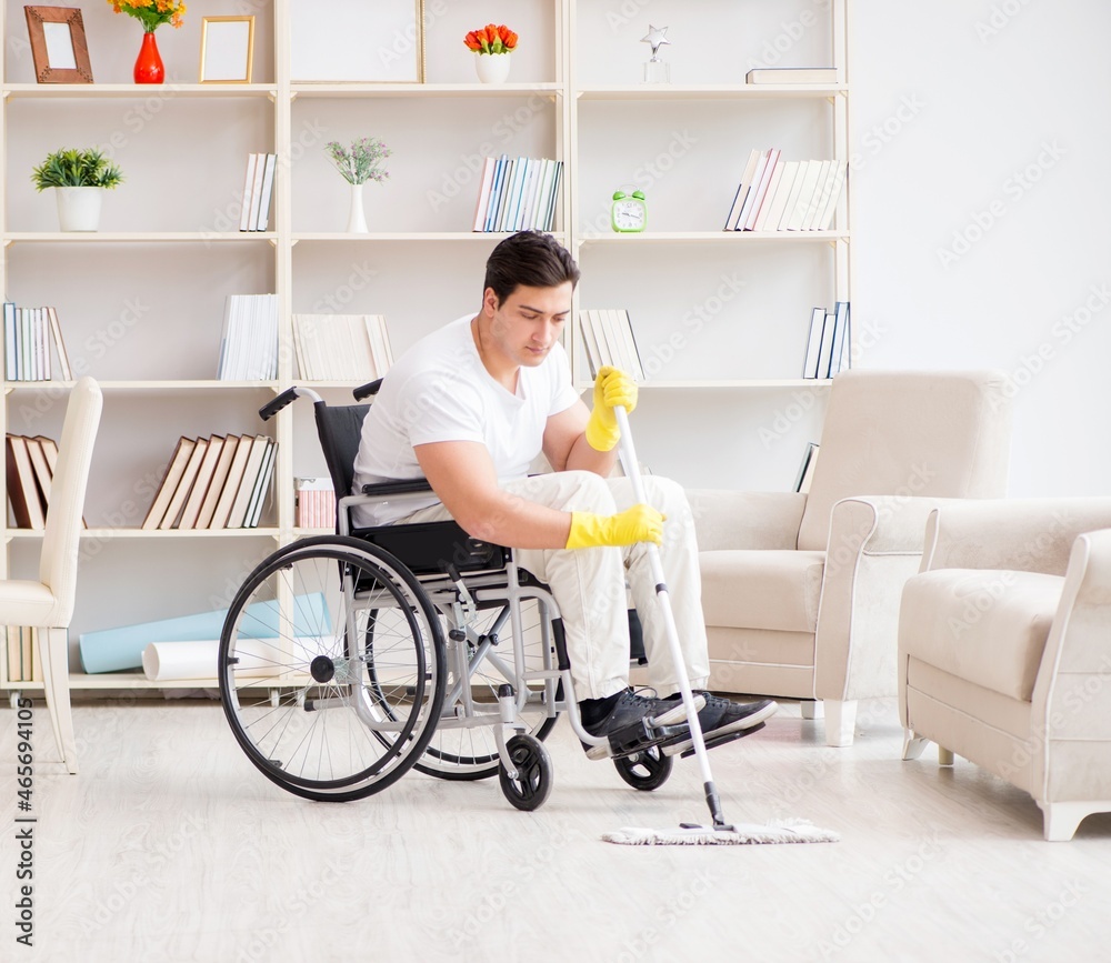 Disabled man cleaning floor at home Disabled man cleaning floor at home