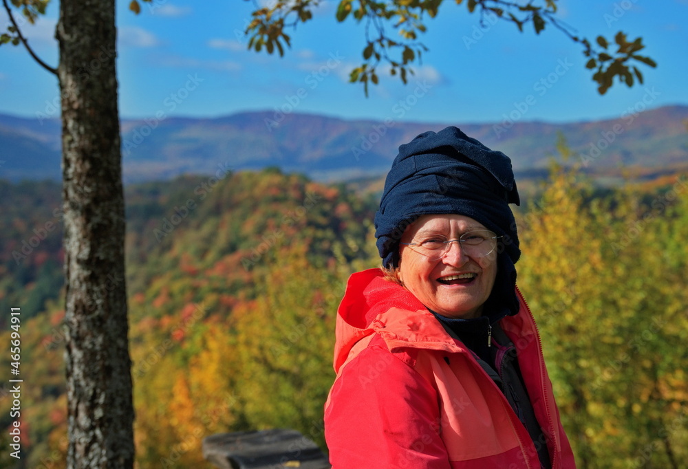 Portrait of senior woman with autumn forest in background Portrait of senior woman with autumn forest in background