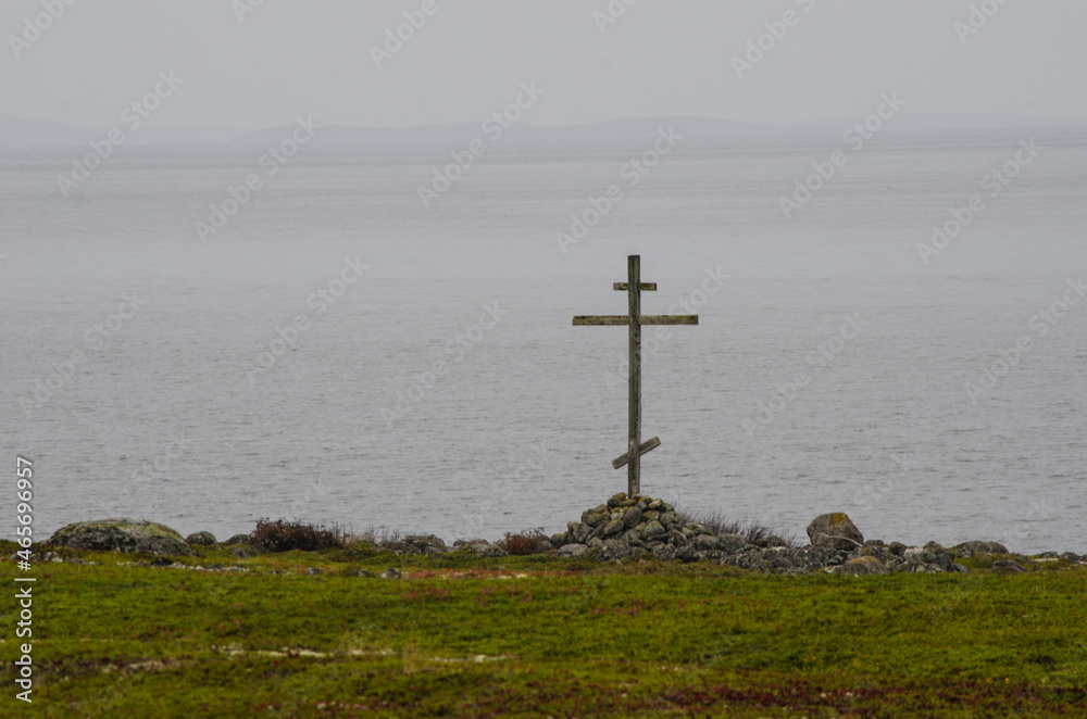 Wooden worship cross on the shore of the White Sea. Russia, Solovki 
