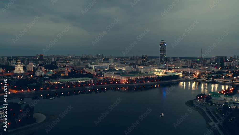 The modern millionaire city is located near a pond. This is the city center, there are many historical buildings and a skyscraper is visible. The backlight is shining brightly The modern millionaire city is located near a pond. This is the city center, there are many historical buildings and a skyscraper is visible. The backlight is shining brightly