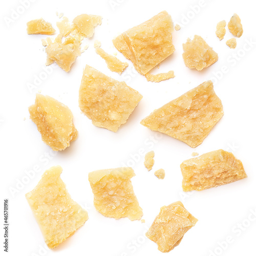 Pieces of parmesan cheese isolated on white background. Pattern. Parmesan top view. Flat lay.