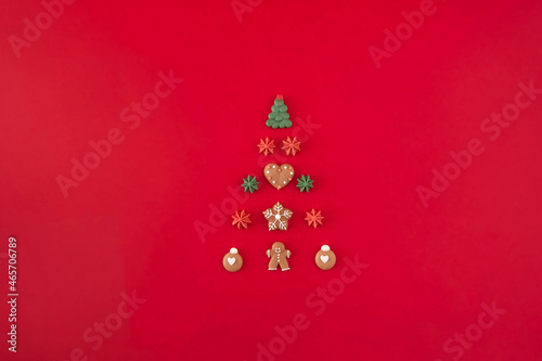 Christmas tree of cookies on the red background. Christmas holiday creative concept.