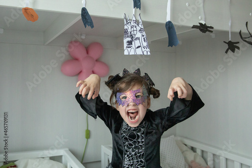 Картината върху платно girl on a home halloween party in kids room making scary faces
