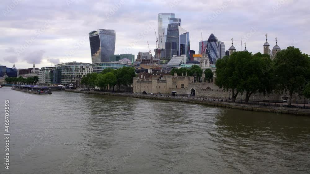 London city skyline next to the historic Tower of London castle. England London city skyline next to the historic Tower of London castle. England