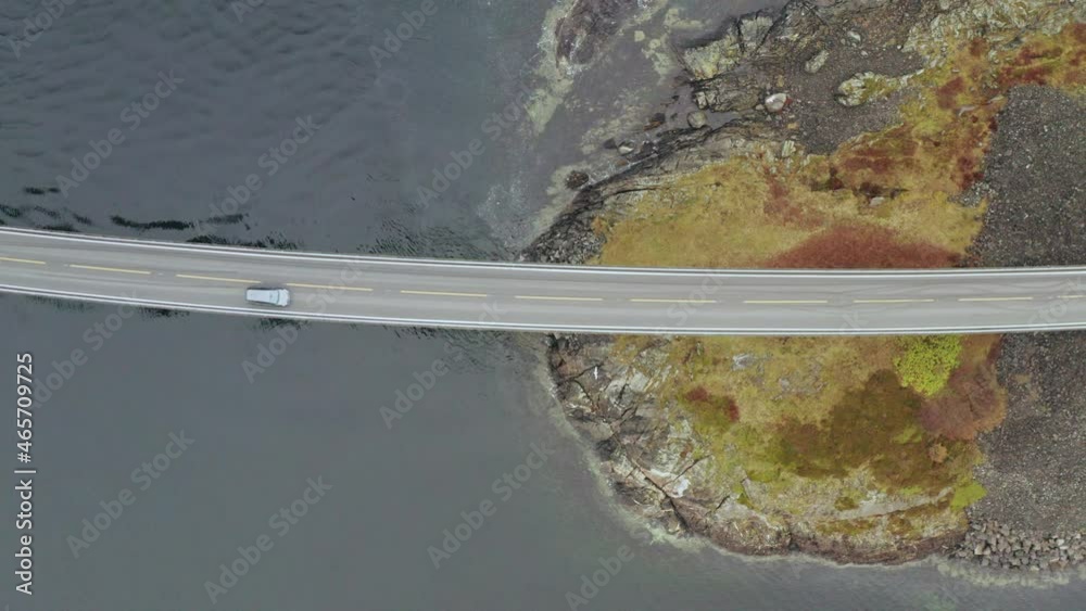Top Down Aerial Of Car Driving at Atlantic Ocean Road In More and Romsdal, Norway. - Drone Shot, Birds Eye View Top Down Aerial Of Car Driving at Atlantic Ocean Road In More and Romsdal, Norway. - Drone Shot, Birds Eye View