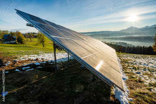 Photovoltaic panels on a mountain meadow in the autumn morning