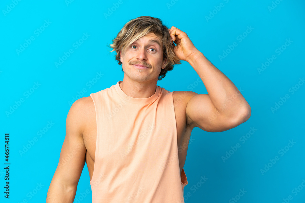 Naklejka premium Handsome blonde man isolated on blue background with an expression of frustration and not understanding