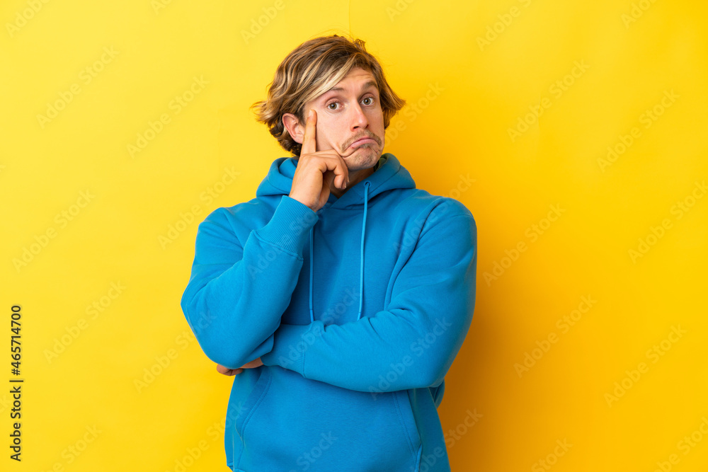 Handsome blonde man isolated on yellow background thinking an idea Handsome blonde man isolated on yellow background thinking an idea