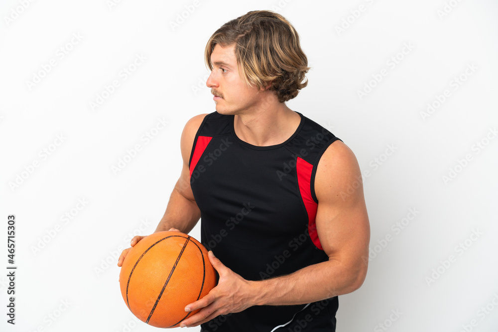 Young blonde man isolated on white background playing basketball Young blonde man isolated on white background playing basketball