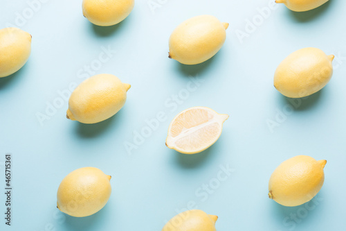 Several yellow bright lemons on a colored background. Bright citruses.