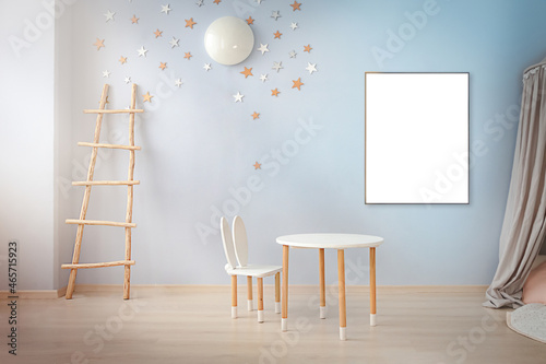 Children's room interior with empty frame on the wall for your design.