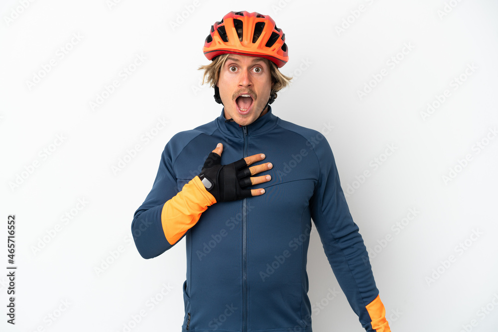Young blonde cyclist man isolated on white background surprised and shocked while looking right - obrazy, fototapety, plakaty 