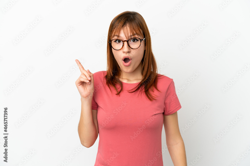 Redhead girl isolated on white background intending to realizes the solution while lifting a finger up Redhead girl isolated on white background intending to realizes the solution while lifting a finger up