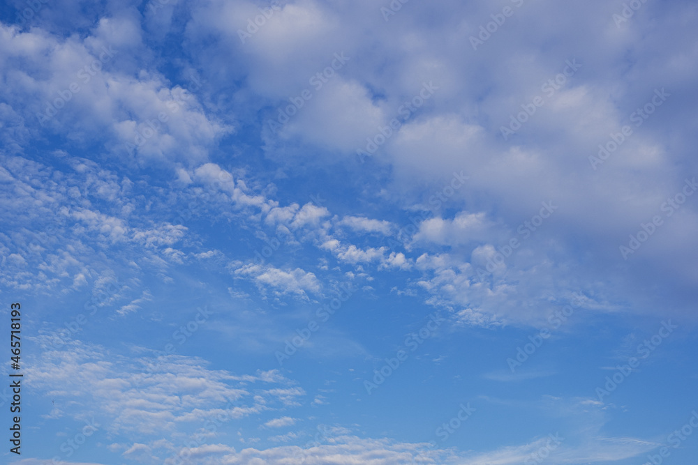 Whispers of the Sky: Floating Clouds on a Blue Canvas