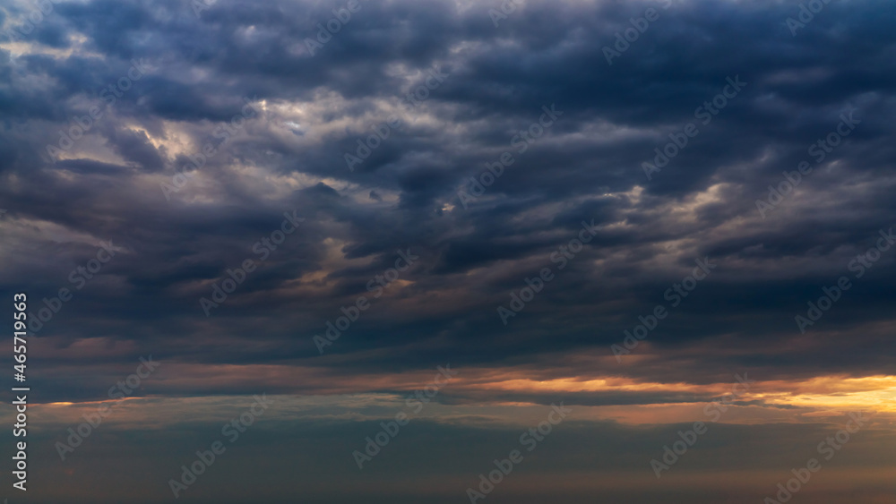 Sun beams or rays breaking through the dark clouds at sunset. Beautiful spectacular conceptual meditation background. Artistic golden sunset edit. Sun beams or rays breaking through the dark clouds at sunset. Beautiful spectacular conceptual meditation background. Artistic golden sunset edit.