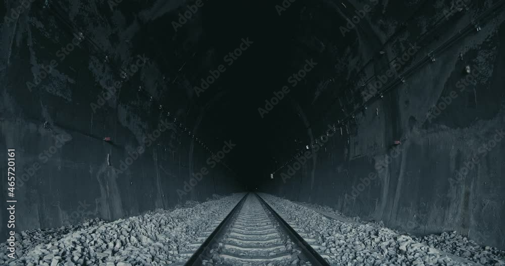 Railway line inside a dark tunnel at the end, No light at the end of tunnel. The symbol of hopeless.