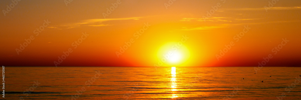 beautiful sunset on the beach with calm sea panorama