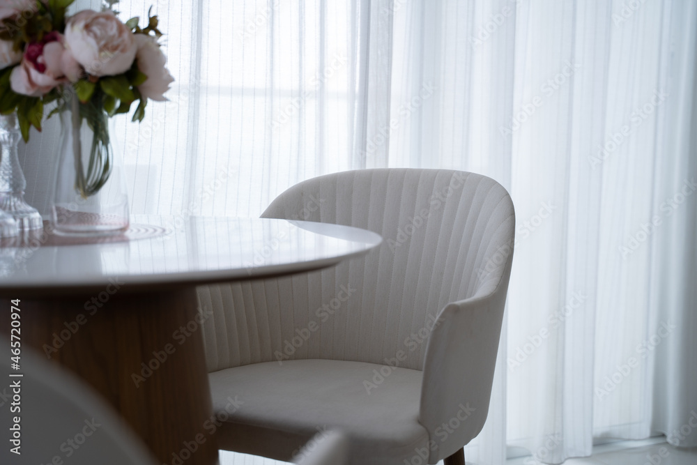 small chair and table set decoration in hotel apartment. interior design white living room. sofa and table near window and curtains. small chair and table set decoration in hotel apartment. interior design white living room. sofa and table near window and curtains.